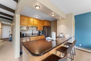 a kitchen with wooden cabinets and a large island at Lake Cliffe #307 Building A in Dillon