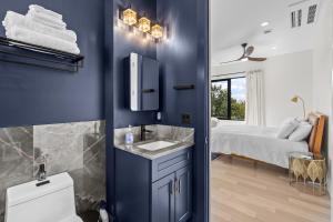 a bathroom with blue walls and a sink and a bed at Penthouse West - Mountain Views in Asheville +25 photos