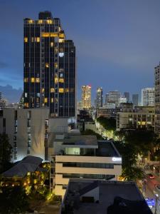 a city skyline at night with tall buildings at Kinboshi Silom in Bangkok