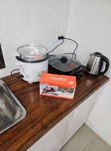 a counter top with a pot and a box on it at starbox dream vacation & car rentals in Nadi