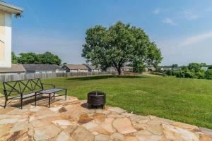 a park with a bench and a trash can and a tree at Magnolia in Clarksville