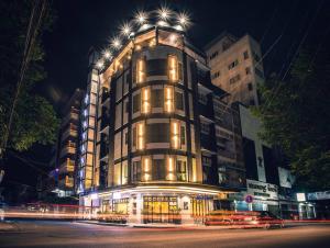 a tall building with lights on it at night at Lavanya Boutique Hotel in Phnom Penh
