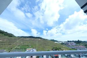 a view of a hill from a balcony at Comfy Sofy-Bunny Vintage Penthouse in Tanah Rata