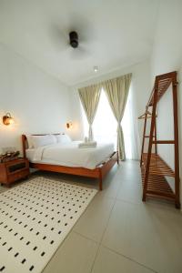 a bedroom with a bed with a ladder and a window at Comfy Sofy-Bunny Vintage Penthouse in Tanah Rata