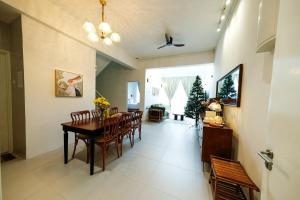 a dining room with a table and chairs at Comfy Sofy-Bunny Vintage Penthouse in Tanah Rata