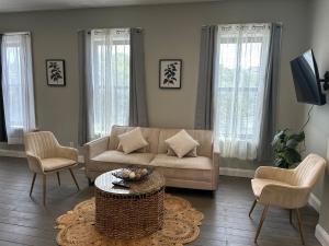 a living room with a couch and chairs and a table at Bright & Airy 1 BDRM Private Apt in Albany