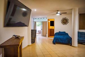 a bedroom with a bed and a living room at Oceanfront 4BR 20 PAX in Puerto Vallarta