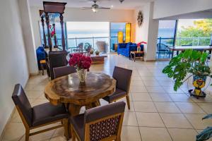 a dining room with a table and chairs at Oceanfront 4BR 20 PAX in Puerto Vallarta