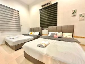 a room with two beds in a room at SSR PORT DICKSON SEMI-D 15ppl STAY-BBQ 5min Sea VIEW in Port Dickson