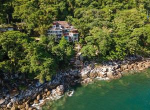 an aerial view of a house on a rocky shore at Oceanfront 4BR 20 PAX in Puerto Vallarta
