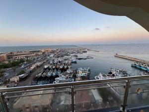 a view of a harbor with boats in the water at The Royal Sea View Suite in Port Said