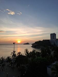 a sunset view from the balcony of a condo at Apto Buritaca Piso 8 in Rodadero