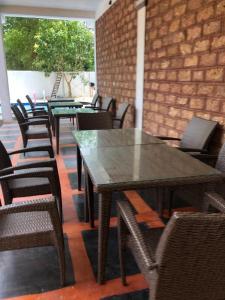 a group of tables and chairs in a restaurant at Ovenro Safari Hotel & Restaurant Yala, Kataragama in Kataragama +25 photos