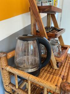 a black tea kettle on a wooden basket at Bauhaus Hostel Cafe in Don Sak