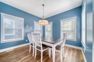 a dining room with blue walls and a table and chairs at Spacious Dog-Friendly Getaway with Year-Round Pool & Hot Tub in South Haven