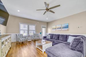 a living room with a couch and a ceiling fan at Spacious Dog-Friendly Getaway with Year-Round Pool & Hot Tub in South Haven