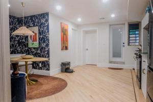 a living room with a table and a dining room at Charming Garden Lvl Brownstone in Brooklyn