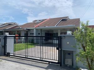 a gate in front of a house at SSR PORT DICKSON SEMI-D 15ppl STAY-BBQ 5min Sea VIEW in Port Dickson