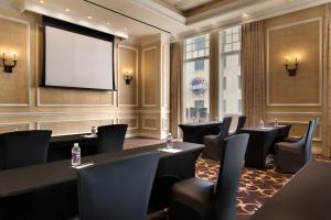 a conference room with tables and chairs and a projection screen at Caesars New Orleans in New Orleans