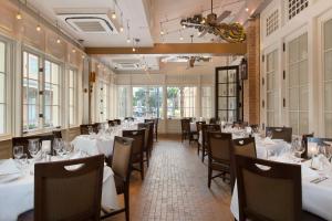 a dining room with white tables and chairs at Harrah's New Orleans Hotel & Casino - A Caesars Rewards Destination in New Orleans
