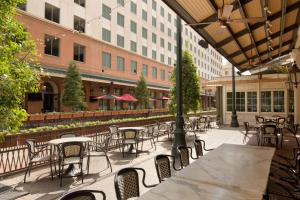 an outdoor patio with tables and chairs and buildings at Harrah's New Orleans Hotel & Casino - A Caesars Rewards Destination in New Orleans