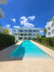 a large swimming pool in front of a building at Ona Residences Punta Cana in Punta Cana