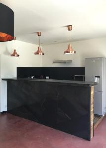 a black counter in a room with three lights at La Datcha Delicatessen in Tulette