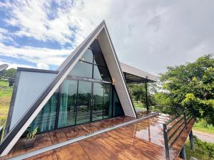 a house with a triangular roof and glass windows at Freedom home khaokho in Khao Kho