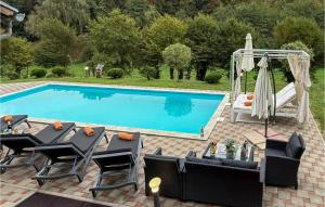 a swimming pool with a table and chairs next to it at Lovely Home In Tuhelj With Sauna in Tuhelj +34 photos