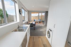 a kitchen with a sink and a dishwasher at Dusky Dream Te Anau Luxury Accommodation in Te Anau