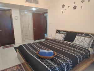 a bedroom with a large bed with a basket on it at Cityscape Retreat Apartment in Sharjah