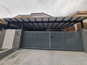 a garage door with a metal gate in front of a house at Modern Nilai Homestay at Nilai, USIM, INTI, Mila University, Aurelius Hospital, Aminah Event Hall, Sepang F1, KLIA 