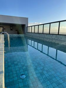 a swimming pool on top of a building at Studio Flat Cuiabá in Cuiabá