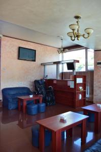 a living room with two tables and a couch at Villa Roberto in Constanţa