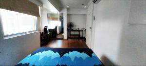 a room with a bed with a mountain design on it at 2 BR loft-type condo Fort Victoria in Manila +22 photos