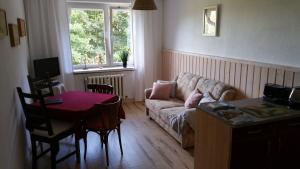 a living room with a couch and a table at Ferienwohnung Wolf in Gräfenroda +14 photos