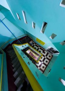 a ceiling view of a staircase in a building at Social Backpacker Hostel & Rooftop Bar in Battambang