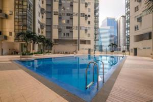 a large swimming pool in the middle of a building at 2 BR loft-type condo Fort Victoria in Manila
