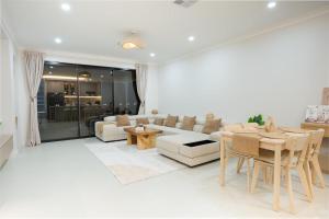 a living room with a couch and a table at The Oak & Sand House 3BHK Cosy stay in Modbury