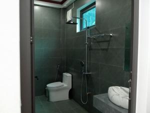 a bathroom with a shower with a toilet and a sink at Tam Coc Mountain Light Homestay in Ninh Binh +38 photos