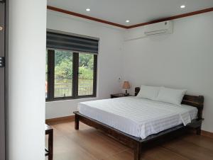 Ένα ή περισσότερα κρεβάτια σε δωμάτιο στο Tam Coc Mountain Light Homestay