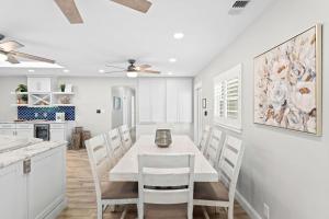 a kitchen and dining room with a white table and chairs at 445 Watts Way in Cocoa Beach +51 photos