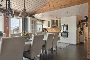 a kitchen and dining room with a table and chairs at Modern Family Cabin Near Vinterland Ski Resort in Lifjell