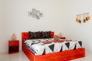 a bedroom with a wooden bed with stuffed animals on it at Tropical Villa with Swimming Pool in Selong Belanak +15 photos