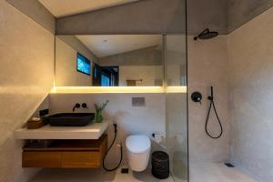 a bathroom with a sink and a glass shower at Villa Suki in Canggu +88 photos