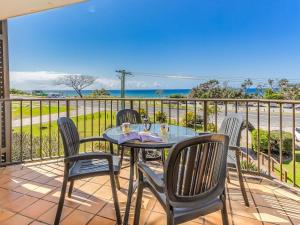 a table and chairs on a balcony with a view of the ocean at Cabarita Beachfront Ocean View 12 in Cabarita Beach