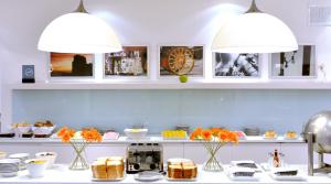 a kitchen with two lights above a table with food at Rochester Hotel Concept in Buenos Aires