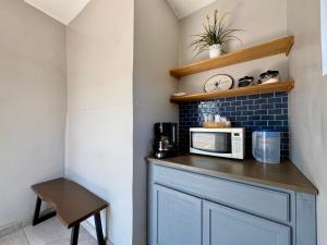 a kitchen with a counter with a microwave on it at Casa Petri Hotel in Ensenada