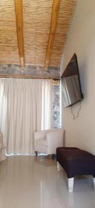 a living room with a couch and a window at canto del viento in Tilcara