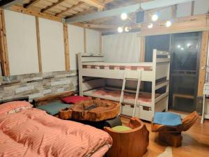 a bedroom with a bed and a bunk bed and a ladder at Glamping Himeshara - Vacation STAY 43046v in Kirishima